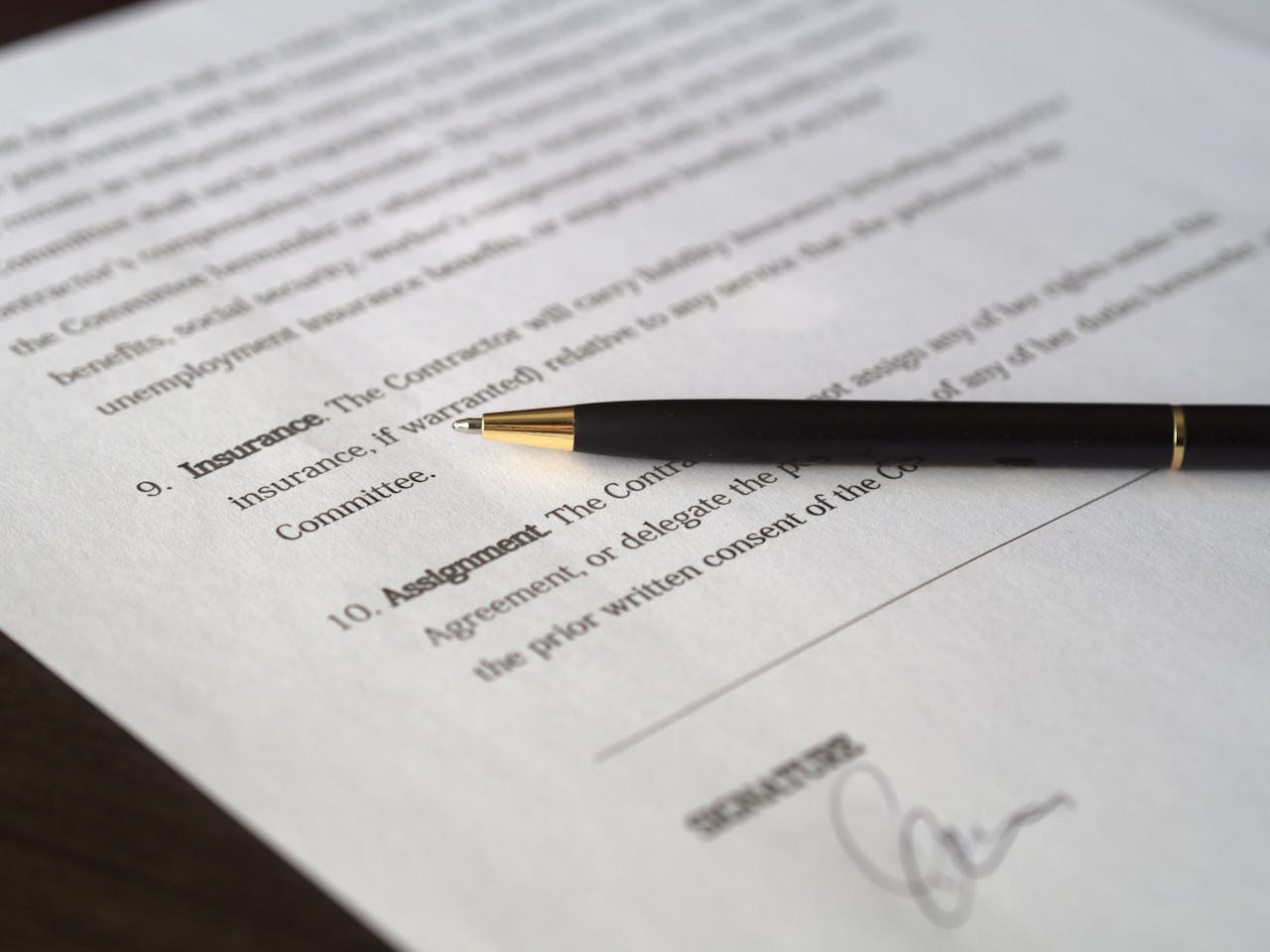 services-01 Close-up image of a business contract and pen, signed and ready for agreement.