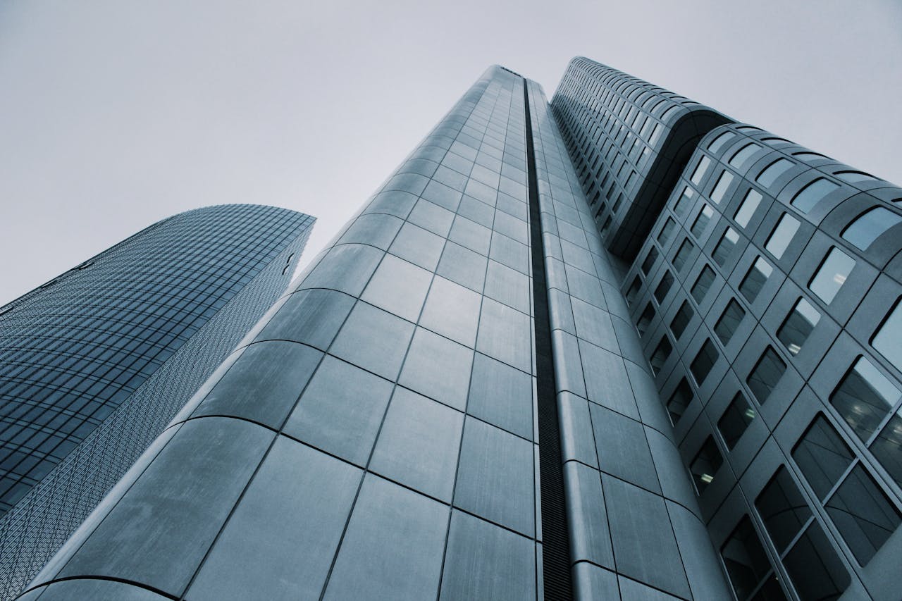 heros-img Low angle view of modern skyscrapers with glass and steel design. Perfect for corporate imagery.
